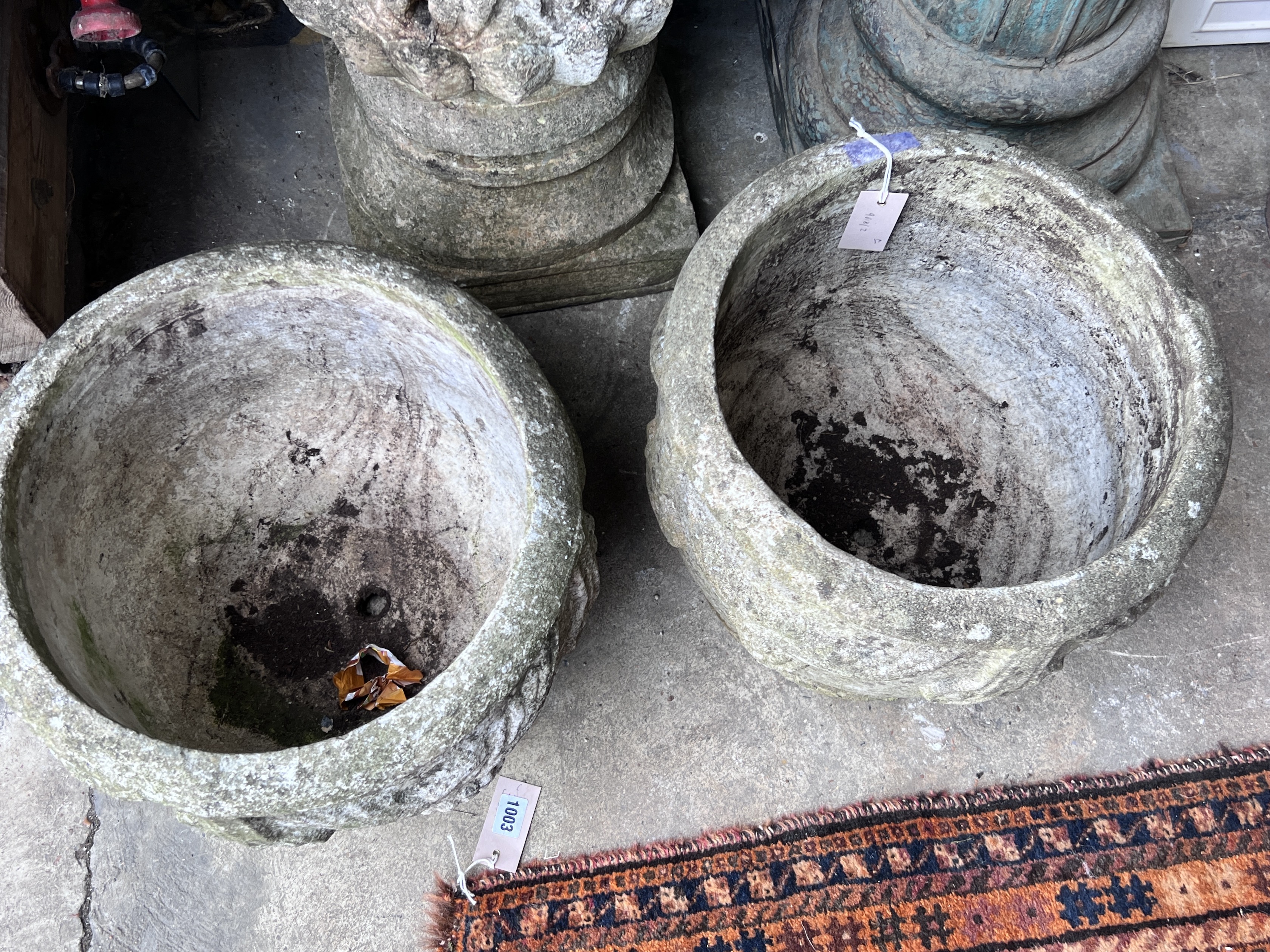 A pair of circular reconstituted stone garden planters, diameter 37cm, height 31cm